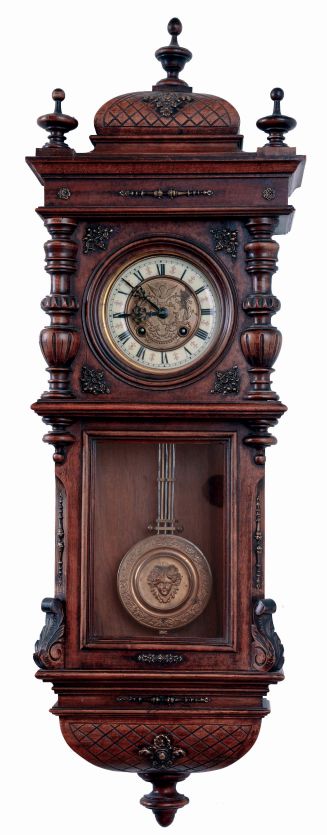 Germany, smaller walnut cased spring "Vienna" regulator, double door style, with embossed dial center bearing a cherubs face below 12, and the embossed pendulum with a similar large central cherubs face. 8 days, time and gong strike, c1900
