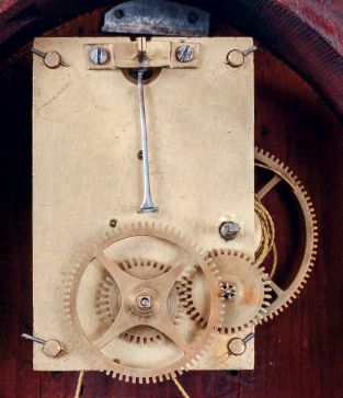 Boston area lyre clock, mahogany and mahogany veneer case with heavily molded base and acanthus carved bracket, throat panel with leaf and scroll carving and decorated tablet, brass bezel with convex glass, Roman numeral white painted metal dial, blued steel barbed hands, 8 days, weight driven timepiece movement, c1830 with alterations.