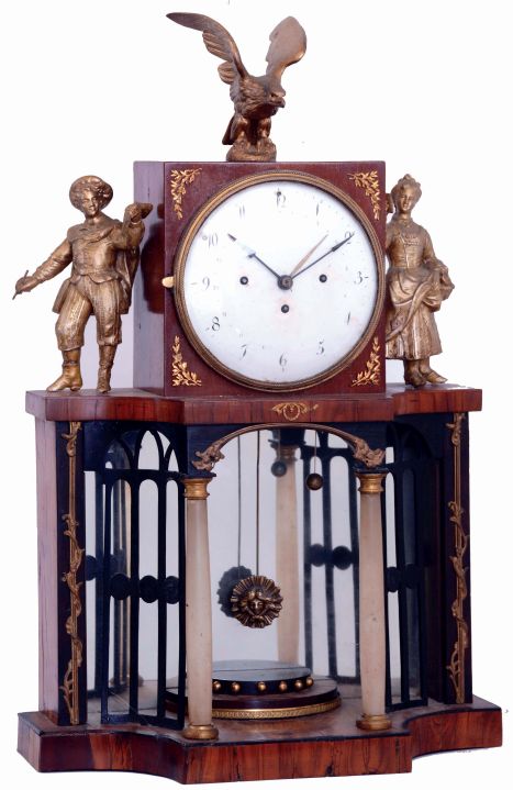 Austria, shelf or mantel clock, fruitwood case, base with arcaded portico with mirrored back, and alabaster columns supporting the square clock case, flanked by male and female figures and with eagle finial, Arabic numeral white enamel dial, 2 day grand sonnerie striking brass movement with date display, c1820