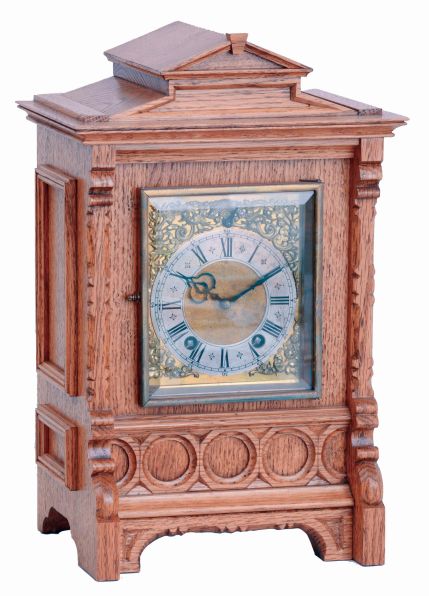 Lenzkirch, Germany, bracket clock, oak case of architectural form with carved and applied ornament, composite dial with Roman numeral silvered chapter ring and gilt spandrels, blued steel hands, 8 days time and strike movement with ting tang quarters on two gongs, serial #1358164
