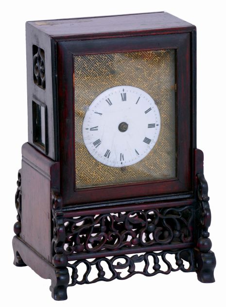 China, bracket clock, camphor wood case with glazed panels, resting on a pierced and carved base, Roman numeral white enamel dial mounted to a brass plate, brass time and strike fusee movement with verge escapement, and engraved back plate