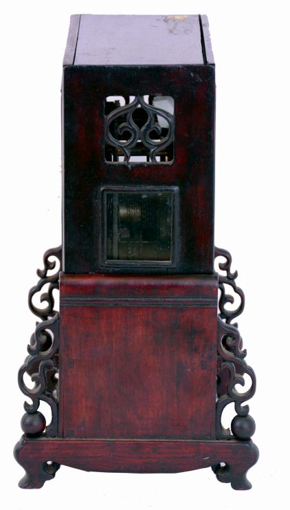 China, bracket clock, camphor wood case with glazed panels, resting on a pierced and carved base, Roman numeral white enamel dial mounted to a brass plate, brass time and strike fusee movement with verge escapement, and engraved back plate