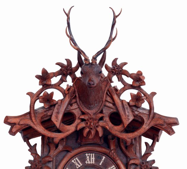 German, Black Forest cuckoo, smaller size but with highly detailed carving of edelweiss flowers, surmounted by a finely detailed stags head, c1920