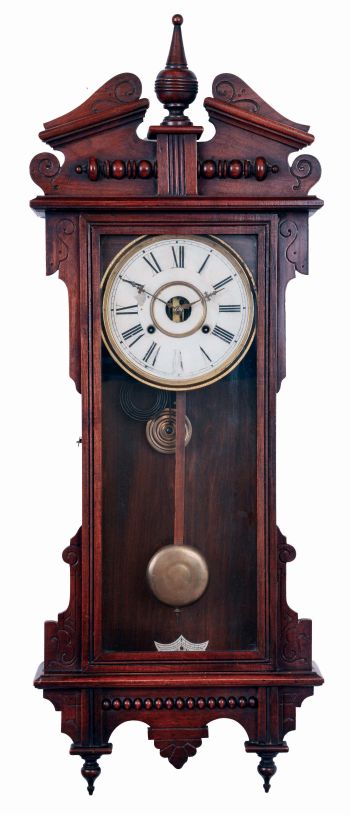 Waterbury Clock Co., Waterbury, Conn., "Eton" wall hanging clock in a walnut case with a spring driven, 8 days, time and strike movement, c1906.