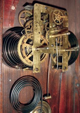 Waterbury Clock Co., Waterbury, Conn., "Eton" wall hanging clock in a walnut case with a spring driven, 8 days, time and strike movement, c1906.