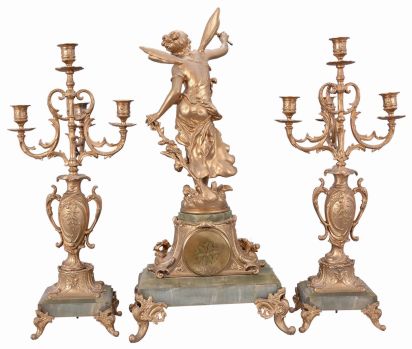 France, three-piece figural mantel clock with garniture, green onyx base on cast rococo feet supporting clock with porcelain dial set within an ornate tapered column, surmounted by a cast spelter female figure with delicate wings. The movement is an 8 day spring driven time and strike pendule de Paris signed by Marti & Cie. Matching onyx and cast metal candelabra hold four candles each.