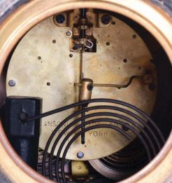 Ansonia Clock Co., New York, "Undine" 8 day, time and strike, spring driven brass movement mantel clock with a figure of "Gloria" on top.