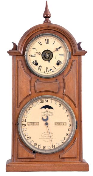 Ithaca Calendar Clock Co., Ithaca, New York, "No. 8 Shelf Library" double dial calendar clock with a spring driven, 8 day time, strike and alarm movement in a walnut case.