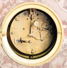 France, 3 piece mantel garniture set, 8 day, time and strike, spring driven movement, Art Deco case of polychrome pink marble with dark marble accents, applied metal ornaments, white enamel dial, and pair of matching tazze. Brass Pendule de Paris movement is signed "FC".