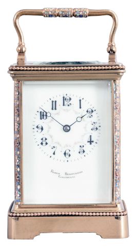 France, for Frank Herschede, Cincinnati, an 8 day, two train carriage clock with champleve enamel ormnament, polished brass Corniche case with enamel accented corners and handle, Arabic numeral white enamel dial with floral featoons, blued steel Breguet style hands, 8 day, time and strike movement with lever platform, counting the hours on a gong