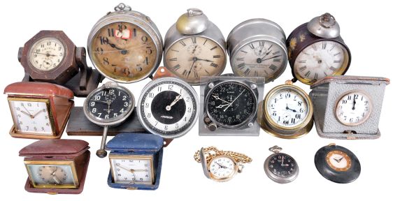 Clocks- 16 (Sixteen) Alarm, Travel, and Car: small clocks including and 8 day Waltham with black dial for the U.S. Navy, a Pierce-Arrow car clock, a Taunus 8 day car clock in brass and glass dash mount, as well as several alarm clocks and travel clocks.