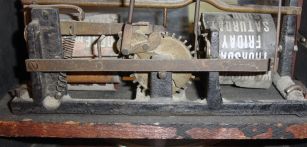 Ithaca Clock Co., Ithaca, New York, "3 1/2 Parlor" Calendar Clock with black and silvered roman numeral dial, tri-foil hands, lower clear glass reveals the glass calendar dial marked "H. B. Horton