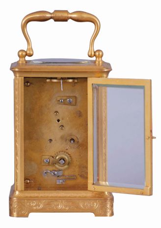 France, for Hall & Co., Manchester, an engraved carriage timepiece for the English market, the glazed, gilt Corniche case with foliate ornament, Roman numeral white enamel dial, blued steel Breguet style hands, 8 day movement with lever platform, the back plate marked "B" within a circle