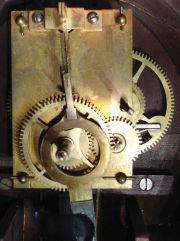 Howard & Davis, Boston, Massachusetts Wall Regulator (No. 5 size), the cherry case with turned wooden bezel over the roman numeral zinc and printed paper dial signed "Howard & Davis/Boston", half round frames holding the black and gold glasses, the lower rectangular box glass with oval pendulum aperture, eight day time- only brass, weight powered movement with recoil escapement, regulated by a wooden pendulum rod and brass faced bob with blued-steel moon hands.