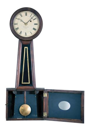 Howard & Davis, Boston, Massachusetts Wall Regulator (No. 5 size), the cherry case with turned wooden bezel over the roman numeral zinc and printed paper dial signed "Howard & Davis/Boston", half round frames holding the black and gold glasses, the lower rectangular box glass with oval pendulum aperture, eight day time- only brass, weight powered movement with recoil escapement, regulated by a wooden pendulum rod and brass faced bob with blued-steel moon hands.