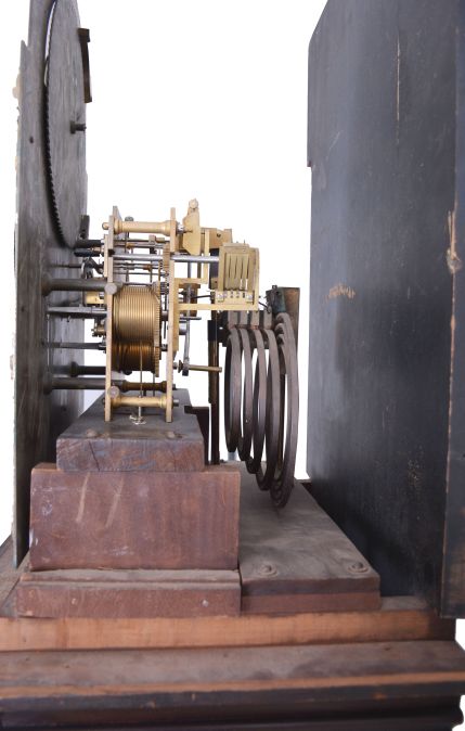 Germany, tall clock, 8 day, time, strike and chime on gongs, three brass weight driven movement in a mahogany case with beveled glass trunk door, broken arch top, paw feet, three wooden finials and applied moldings on base with brass dial, silvered chapter ring, applied brass spandrels, moon phase and seconds bit.