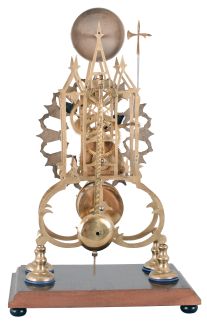 England, 3 spire Gothic frame, single fusee skeleton clock, with a silvered fretted dial, passing strike [single bell on the hour], no dome, mounted to a rectangular wooden base.