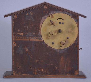 F. Kroeber Clock Co., New York, "Mountain Boy", 30 hour, time and alarm, spring driven brass movement in a walnut case resembling a cottage or barn with bisque figure of a boy urging the owner to rise.