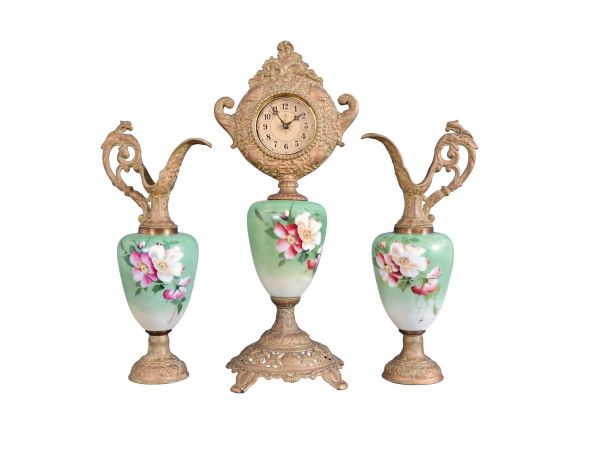 F. Kroeber Clock Co., New York, "China K457" 3 piece mantel garniture, clock and matching ewers, 30 hour, time only, spring driven lever escapement mounted on green porcelain with floral motif supported and topped by cast spelter parts with finish simulating old bronze with verdigris.