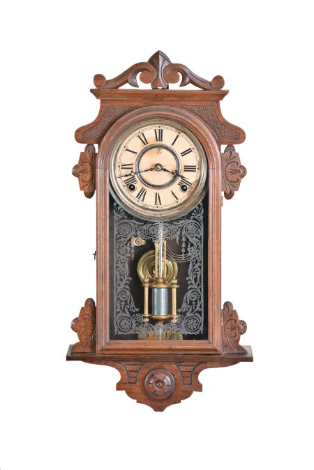 F. Kroeber Clock Co., New York, "Eight Day Rambler" wall hanging clock, 8 day, time and strike, spring driven movement in a walnut case with cathedral gong, 5 inch paper dial, and single barrel pendulum.