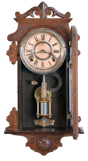 F. Kroeber Clock Co., New York, "Eight Day Rambler" wall hanging clock, 8 day, time and strike, spring driven movement in a walnut case with cathedral gong, 5 inch paper dial, and single barrel pendulum.