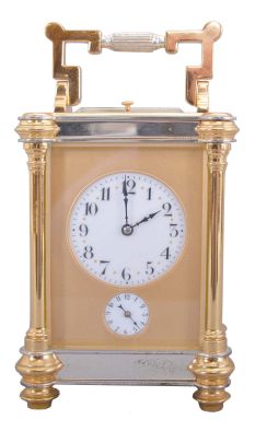 Jules Desjardin, France, carriage clock, time, strike, repeat & alarm, in a two-tone round column case, with round white dials behind a frosted gilt mask with the Arabic numerals separated by gold stars at the half hour positions. 18462
