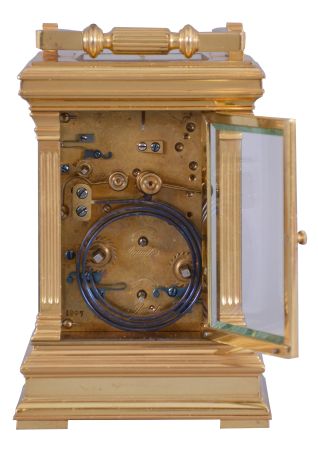 France, a large, Anglaise cased carriage clock with grand sonnerie striking, the glazed, gilt case with molded top and base, the corners with fluted pilasters, Arabic numeral white enamel dial with gilt center and mask, blued steel distaff hands, 8 day time, strike, and alarm movement with lever platform, sounding grand or petit quarters in passing, and repeating the last hour and quarter on demand