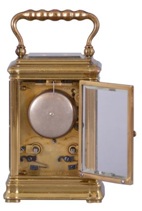 Breguet, Paris, a 3/4 size striking carriage clock, glazed brass Gorge case, white enamel dial with blue Roman numerals on a gray ground, with gold, Arabic numeral, outer five minute markers, blued steel Breguet style hands, and with engine turned, gilt mask, the top glass also backed with a matching, engine turned plate with oval aperture for viewing the escapement, 8 day, two train movement with lever platform and cut bimetallic balance, striking the hour and half hour on a bell, serial #1316