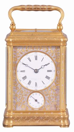 Drocourt, for Tiffany, Reed & Cie, Paris, a Gorge cased, hour repeating carriage clock with cold painted enamel ornament, gilt case with floral engraving and mauve accents, Roman numeral white enamel dial with engraved, gilt mask, also enhanced with mauve colored cold enamel, blued steel Breguet style hands, 8 day time, strike, and alarm movement with lever platform, repeating the last hour on demand, the back plate with the mark of Drocourt, serial #11150
