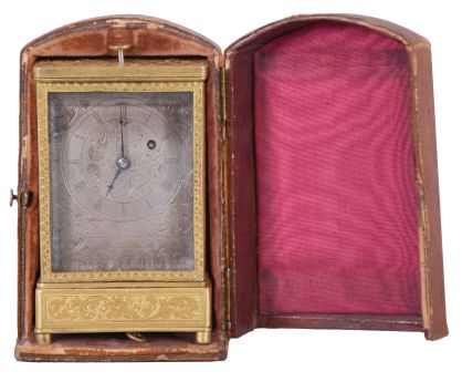 Austria, quarter repeating miniature carriage clock, the rectilinear, gilt brass case on turned feet, front and sides with foliate engraving, carrying handle folding flush with the case top, Roman numeral silvered dial, with engraving matching the case, blued steel hands, round, 30 hour verge fusee movement with blued steel gongs, repeating the last hour and quarter on demand, together with its original leather covered, wooden travel case
