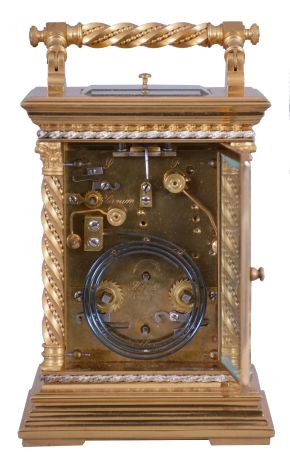 France, a large and unusual hour repeating carriage clock, the glazed, gilt case with stepped base, corners with twisted, beaded columns, the top with carrying handle of the same design as the columns, smaller twist and bead silvered bands above base and below cornice, Arabic numeral white enamel dials decorated with floral garlands and with double gilt mask, the outer portion fretted and engraved, the inner matted, gold fleur de lis hands, 8 day time, strike, and alarm movement with lever platform and cut bimetallic balance, serial #133