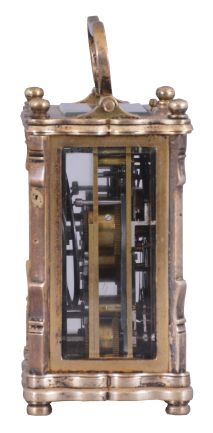 Austria, an unusual three train carriage clock with Viennese striking, date, and alarm, gilt case with corbelled pilasters, top and base with cupids bow molded edges, case back with shuttered apertures for winding and setting, Roman numeral white enamel dial with date and alarm chapters, blued steel trefoil hands, 30 hour time, strike, and alarm movement with cylinder platform, grand sonnerie striking, and repeating the last hour and quarter on demand