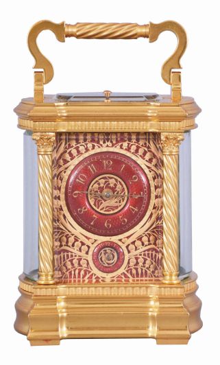 France, a large and extremely decorative carriage clock with grand sonnerie striking, unusual gilt Anglaise variant case with twist columns having Corinthian capitals and turned bases, the molded base and cornice with bowed sides and conforming beveled glasses, top with twist ornamented handle matching the columns, red guilloche enamel dial with convex chapter and gilt Arabic numerals, ornate pierced and chased, gilt dial mask with lily of the valley ornament, gold hands, 8 day time, strike, and alarm movement with lever platform and cut bimetallic balance, sounding grand or petit quarters in passing, and repeating the last hour and quarter on demand, serial #1304, with original leather bound box and key