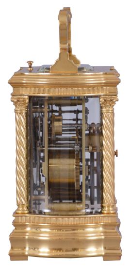 France, a large and extremely decorative carriage clock with grand sonnerie striking, unusual gilt Anglaise variant case with twist columns having Corinthian capitals and turned bases, the molded base and cornice with bowed sides and conforming beveled glasses, top with twist ornamented handle matching the columns, red guilloche enamel dial with convex chapter and gilt Arabic numerals, ornate pierced and chased, gilt dial mask with lily of the valley ornament, gold hands, 8 day time, strike, and alarm movement with lever platform and cut bimetallic balance, sounding grand or petit quarters in passing, and repeating the last hour and quarter on demand, serial #1304, with original leather bound box and key