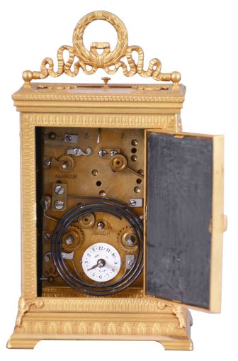 Ed. Chartier, Paris, for Tiffany & Co., New York, a fine gilt bronze and sienna marble carriage clock in the neoclassical style, the case set with five stone panels, within leaf molded surrounds having anthemion corners, the front with Roman numeral white enamel dial and gilt hands, above horn of plenty and lyre ornament, the case sides set with a single, dancing muse, and the top with carrying handle of bowknot and trailing ribbon form, with central laurel wreath, 8 day time, strike, and alarm movement with lever platform, repeating the last hour on demand, serial #12837, case and movement signed by Chartier