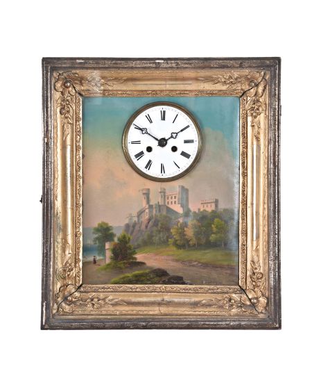 Germany, a very decorative picture frame clock, the deeply molded, gilt frame with applied floral and foliate ornament, with a good oil painting on zinc, depicting a large castle on a cliff overlooking a lake, surrounded by a verdant landscape, and signed at lower right, Roman numeral white enamel dial, blued steel trefoil hands, 30- 60 hour brass, spring driven time and strike movement with silk thread suspension