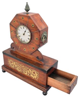 France, mantel clock, 8 day, time only, sping-driven movement with a cylinder escapement in a mahogany case with brass inlay on ball feet supporting a box with drawer that opens to the side, topped with an octagonal head holding a white paper dial with Roman numerals and metal finial.