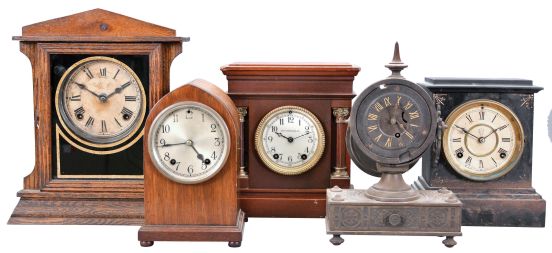 Clocks- 5 (Five) Mantel: small time and strike gothic in a mahogany case, a Sessions time and strike in an oak case, a Waterbury time and strike in a black enameled iron case, a Seth Thomas time and strike in a mahogany case sold by Henry Birks & Sons, and a time only "Tucker Bronze" in a cast iron case.