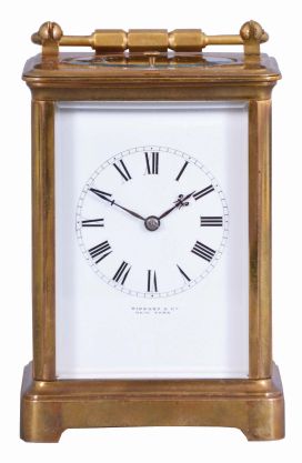 France, for Tiffany & Co., New York, a rare five minute repeating carriage clock, glazed Corniche case, signed Roman numeral white enamel dial, blued steel hands, 8 day, time and strike movement with lever platform and cut bimetallic balance, counting the hours in passing, and repeating the last hour and five minute interval on demand, together with its leather covered wooden travel case