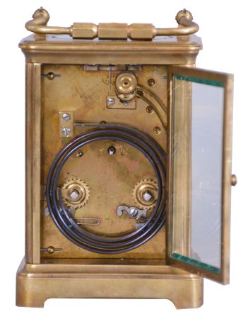 France, for Tiffany & Co., New York, a rare five minute repeating carriage clock, glazed Corniche case, signed Roman numeral white enamel dial, blued steel hands, 8 day, time and strike movement with lever platform and cut bimetallic balance, counting the hours in passing, and repeating the last hour and five minute interval on demand, together with its leather covered wooden travel case