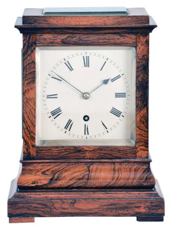England, a miniature rosewood bracket form fusee timepiece, the glazed, architectural case with footed, molded base supporting a bombe surface the upper, rectilinear portion with cavetto cornice molding, Roman numeral silvered dial with blued spade and whip hands, the door with matching, silvered liner, 8 day, brass timepiece movement with recoil escapement, and brass pendulum with tie down for transport