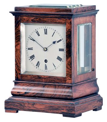 England, a miniature rosewood bracket form fusee timepiece, the glazed, architectural case with footed, molded base supporting a bombe surface the upper, rectilinear portion with cavetto cornice molding, Roman numeral silvered dial with blued spade and whip hands, the door with matching, silvered liner, 8 day, brass timepiece movement with recoil escapement, and brass pendulum with tie down for transport