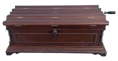 American, Regina Music Box Co., Style No. 6 Orchestral 27" Folding Top Table Model music box also sometimes called the "Casket Model". Mahogany case with applied carving and shaped bracket feet. Interior with original Regina Company celluloid label, the serial number stamped into the cast iron bedplate = 31207, and an 11" double comb mechanism, with removable crank. Includes 23 discs