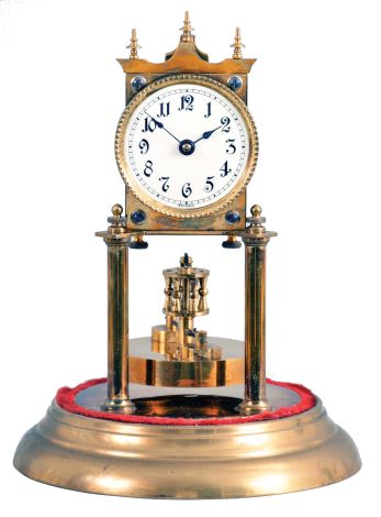 Germany, 400 day or anniversary clock, spring driven, torsion pendulum movement with disc pendulum in a polished brass case with cream porcelain dial under glass dome.