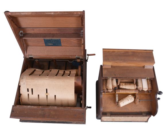 American mechanical organettes- 2 (Two): (1) "The Mechanical Cabinetto", plays large 14 inch wide paper rolls, in a walnut case with gold stenciling; (2) " The Musette", and made by the Mechanical Organette Co., of Newark, NJ, this unit playing small paper rolls that are 3 1/2 inches wide with narrow perforations.