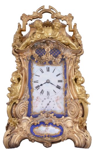 Attributed to Drocourt, Paris, a rare and extremely decorative giant carriage clock in the rococo style, the gilt case replete with scrolls, foliate ornament, and putti, and set with eight gilt and polychrome enamel porcelain plaques featuring garden scenes and frolicking amorini, each on a deep blue field with gilt, foliate border, the Roman numeral dial with blued steel hands, case back with sliding glass panel to allow access for winding and setting, 8 day time, strike, and alarm movement with lever platform, repeating the last hour on demand, gong base marked "A.D." within an oval, serial #29268