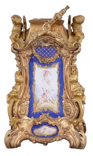 Attributed to Drocourt, Paris, a rare and extremely decorative giant carriage clock in the rococo style, the gilt case replete with scrolls, foliate ornament, and putti, and set with eight gilt and polychrome enamel porcelain plaques featuring garden scenes and frolicking amorini, each on a deep blue field with gilt, foliate border, the Roman numeral dial with blued steel hands, case back with sliding glass panel to allow access for winding and setting, 8 day time, strike, and alarm movement with lever platform, repeating the last hour on demand, gong base marked "A.D." within an oval, serial #29268