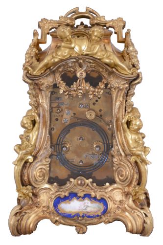 Attributed to Drocourt, Paris, a rare and extremely decorative giant carriage clock in the rococo style, the gilt case replete with scrolls, foliate ornament, and putti, and set with eight gilt and polychrome enamel porcelain plaques featuring garden scenes and frolicking amorini, each on a deep blue field with gilt, foliate border, the Roman numeral dial with blued steel hands, case back with sliding glass panel to allow access for winding and setting, 8 day time, strike, and alarm movement with lever platform, repeating the last hour on demand, gong base marked "A.D." within an oval, serial #29268