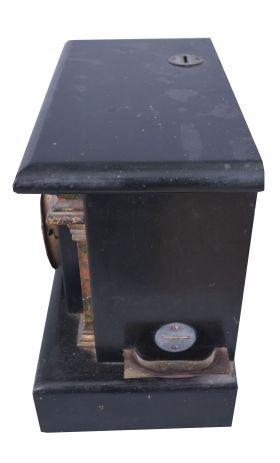 Loheide MFG. Co., St. Louis, Mo., "Automatic Sales Machine" clock and trade stimulator (often called a gambling clock). 8 day, time and token dispenser, spring driven in a black enameled wood case. The clock has a coin slot at the top. When a nickel was deposited, it triggered the strike train of the clock which drives a token dispensing system. A modified countwheel will dispense one, two, and on rare occasion, three tokens in the tray mounted to the side of the clock. Tokens were then exchanged for small items at the retail location.