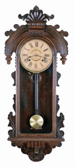 Ansonia Clock Co., New York, "Queen Isabella", 8 day, time and strike in a pressed and carved oak wall case.